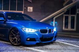 JR Wheels JR18 Bronze alloy wheel mounted on car in an atmospheric setting