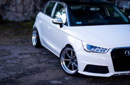 JR Wheels JR19 Grey alloy wheel mounted on car in an atmospheric setting