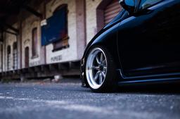 JR Wheels JR19 Grey alloy wheel mounted on car in an atmospheric setting