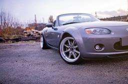 JR Wheels JR19 Grey alloy wheel mounted on car in an atmospheric setting