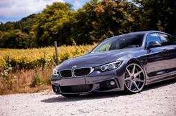 JR Wheels JR20 Grey alloy wheel mounted on car in an atmospheric setting