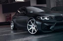 JR Wheels JR20 Grey alloy wheel mounted on car in an atmospheric setting