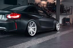JR Wheels JR20 Silver alloy wheel mounted on car in an atmospheric setting