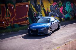 JR Wheels JR20 Silver alloy wheel mounted on car in an atmospheric setting