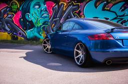 JR Wheels JR20 Grey alloy wheel mounted on car in an atmospheric setting