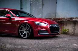 JR Wheels JR20 Grey alloy wheel mounted on car in an atmospheric setting