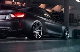 JR Wheels JR20 Grey alloy wheel mounted on car in an atmospheric setting