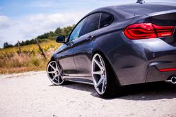 JR Wheels JR20 Grey alloy wheel mounted on car in an atmospheric setting