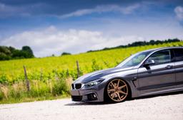 JR Wheels JR20 Bronze alloy wheel mounted on car in an atmospheric setting