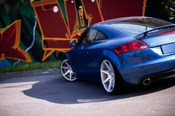 JR Wheels JR20 Silver alloy wheel mounted on car in an atmospheric setting