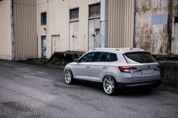 JR Wheels JR20 Silver alloy wheel mounted on car in an atmospheric setting