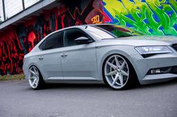 JR Wheels JR20 Silver alloy wheel mounted on car in an atmospheric setting