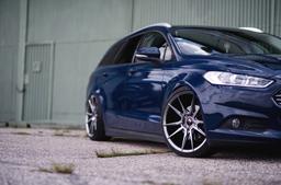 JR Wheels JR21 Grey alloy wheel mounted on car in an atmospheric setting