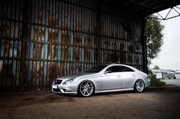 JR Wheels JR21 Silver alloy wheel mounted on car in an atmospheric setting