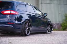 JR Wheels JR21 Grey alloy wheel mounted on car in an atmospheric setting