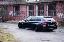 JR Wheels JR21 Black alloy wheel mounted on car in an atmospheric setting