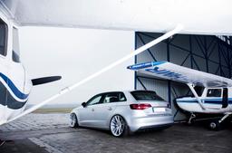 JR Wheels JR21 Silver alloy wheel mounted on car in an atmospheric setting