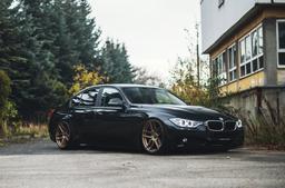 JR Wheels JR25 Bronze alloy wheel mounted on car in an atmospheric setting