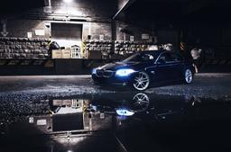 JR Wheels JR25 Silver alloy wheel mounted on car in an atmospheric setting