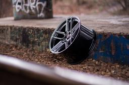 JR Wheels JR25 Grey alloy wheel mounted on car in an atmospheric setting