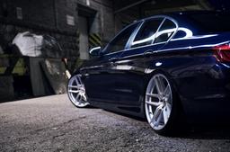 JR Wheels JR25 Silver alloy wheel mounted on car in an atmospheric setting