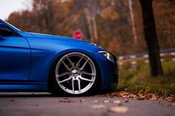 JR Wheels JR25 Silver alloy wheel mounted on car in an atmospheric setting
