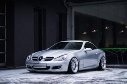 JR Wheels JR26 Silver alloy wheel mounted on car in an atmospheric setting