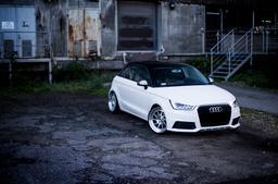 JR Wheels JR26 Silver alloy wheel mounted on car in an atmospheric setting