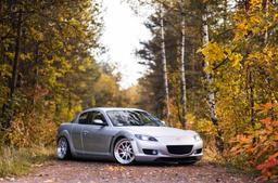 JR Wheels JR26 Silver alloy wheel mounted on car in an atmospheric setting