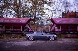 JR Wheels JR26 Silver alloy wheel mounted on car in an atmospheric setting