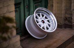 JR Wheels JR26 White alloy wheel mounted on car in an atmospheric setting