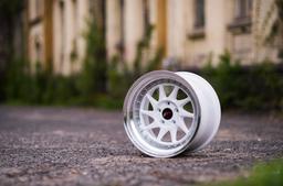 JR Wheels JR26 White alloy wheel mounted on car in an atmospheric setting