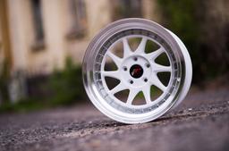 JR Wheels JR26 White alloy wheel mounted on car in an atmospheric setting