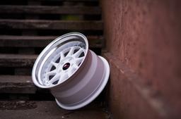 JR Wheels JR26 White alloy wheel mounted on car in an atmospheric setting