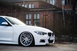 JR Wheels JR28 Silver alloy wheel mounted on car in an atmospheric setting