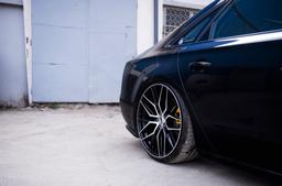 JR Wheels JR28 Musta alumiinivanteet asennettuna autoon tunnelmallisessa ympäristössä