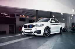 JR Wheels JR28 Black alloy wheel mounted on car in an atmospheric setting