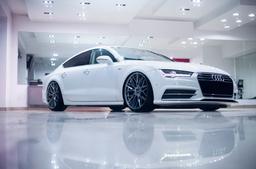 JR Wheels JR28 Grey alloy wheel mounted on car in an atmospheric setting