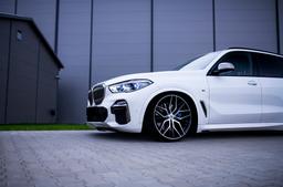 JR Wheels JR28 Svart aluminiumsfelger montert på bil i en stemningsfull omgivelse