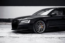 JR Wheels JR28 Grey alloy wheel mounted on car in an atmospheric setting