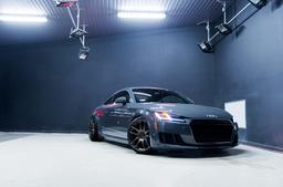 JR Wheels JR29 Bronze alloy wheel mounted on car in an atmospheric setting