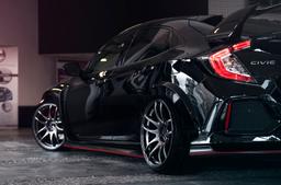 JR Wheels JR29 Grey alloy wheel mounted on car in an atmospheric setting