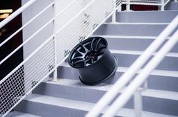 JR Wheels JR29 Black alloy wheel mounted on car in an atmospheric setting