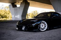 JR Wheels JR29 White alloy wheel mounted on car in an atmospheric setting