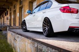 JR Wheels JR29 Bronze alloy wheel mounted on car in an atmospheric setting