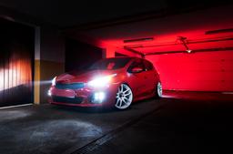 JR Wheels JR29 White alloy wheel mounted on car in an atmospheric setting