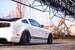 JR Wheels JR30 Bronse aluminiumsfelger montert på bil i en stemningsfull omgivelse