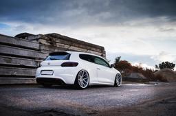 JR Wheels JR30 Silver alloy wheel mounted on car in an atmospheric setting