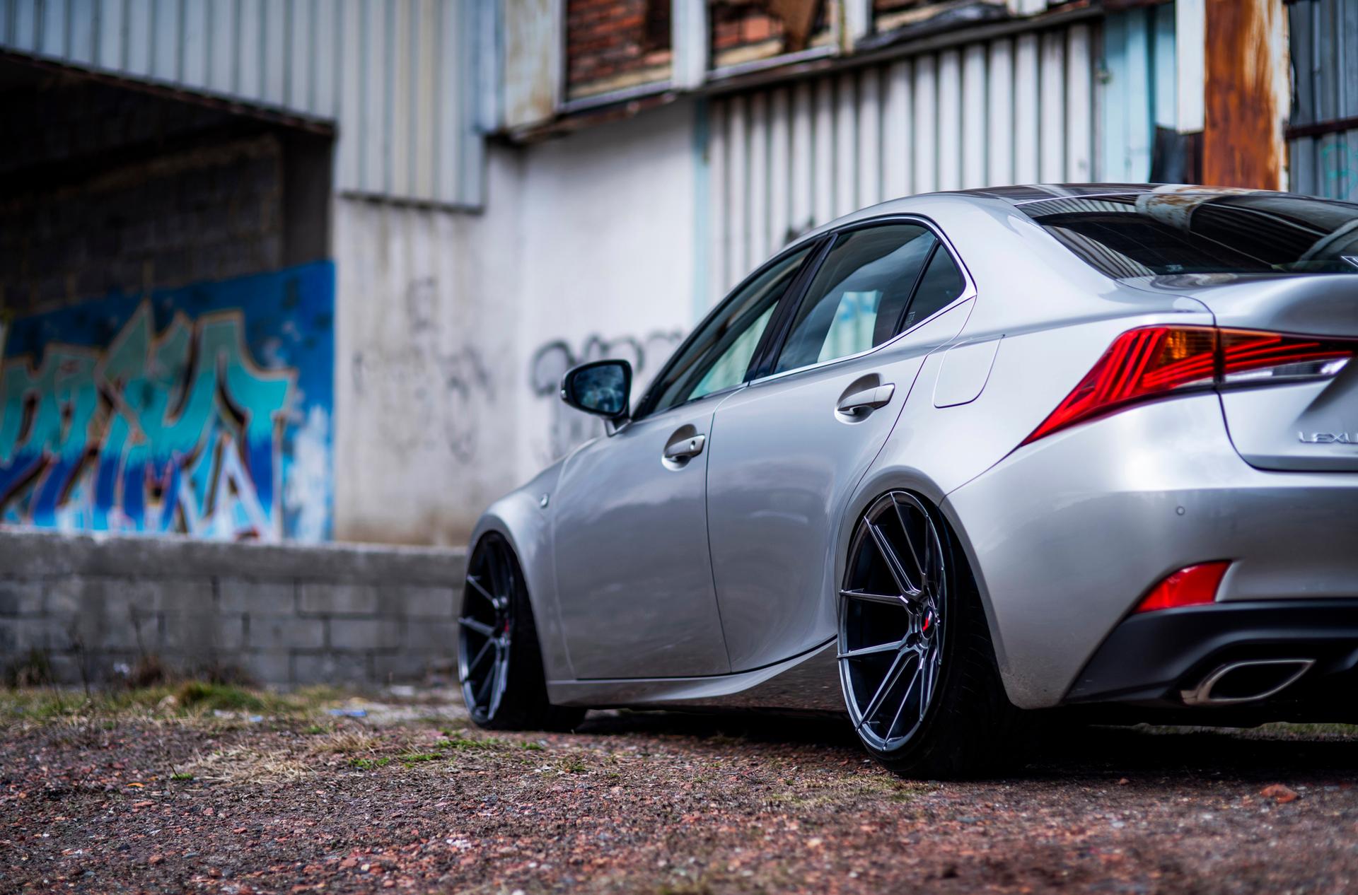 JR Wheels JR30 Grey alloy wheel mounted on car in an atmospheric setting
