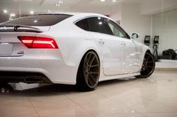 JR Wheels JR30 Bronze alloy wheel mounted on car in an atmospheric setting